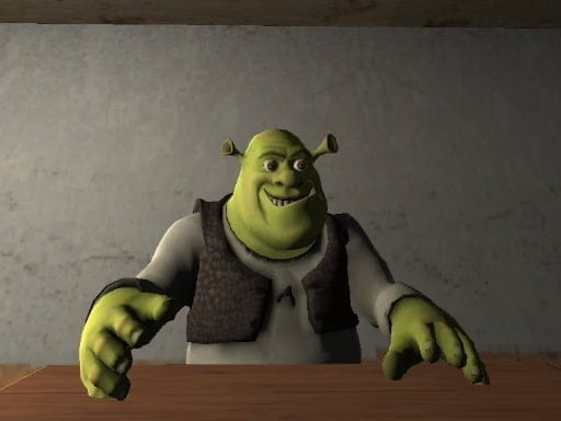 Image of Shrek, the iconic ogre from the DreamWorks animated film, looking up with a mischievous grin. He is wearing a brown vest and has his hands placed on a wooden table. The background suggests a dimly lit room with a grey wall. Shrek's expression hints at a playful or possibly sinister demeanor, leaving the viewer to wonder about his intentions in this particular scene.