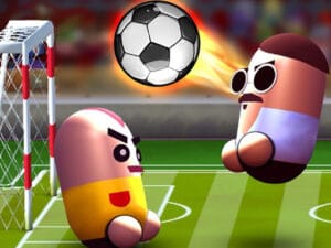 Image of two pill-shaped cartoon characters playing soccer on a green field, with one wearing sunglasses and a mustache near the goal and a flaming soccer ball flying through the air.